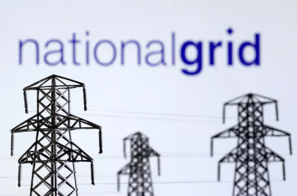 Three electricity pylons with national grid written above